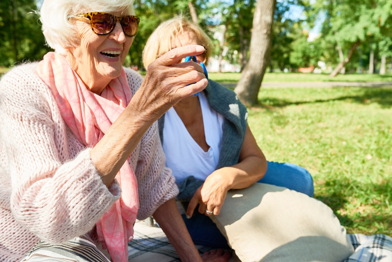 a senior woman playing with a fidget spinner