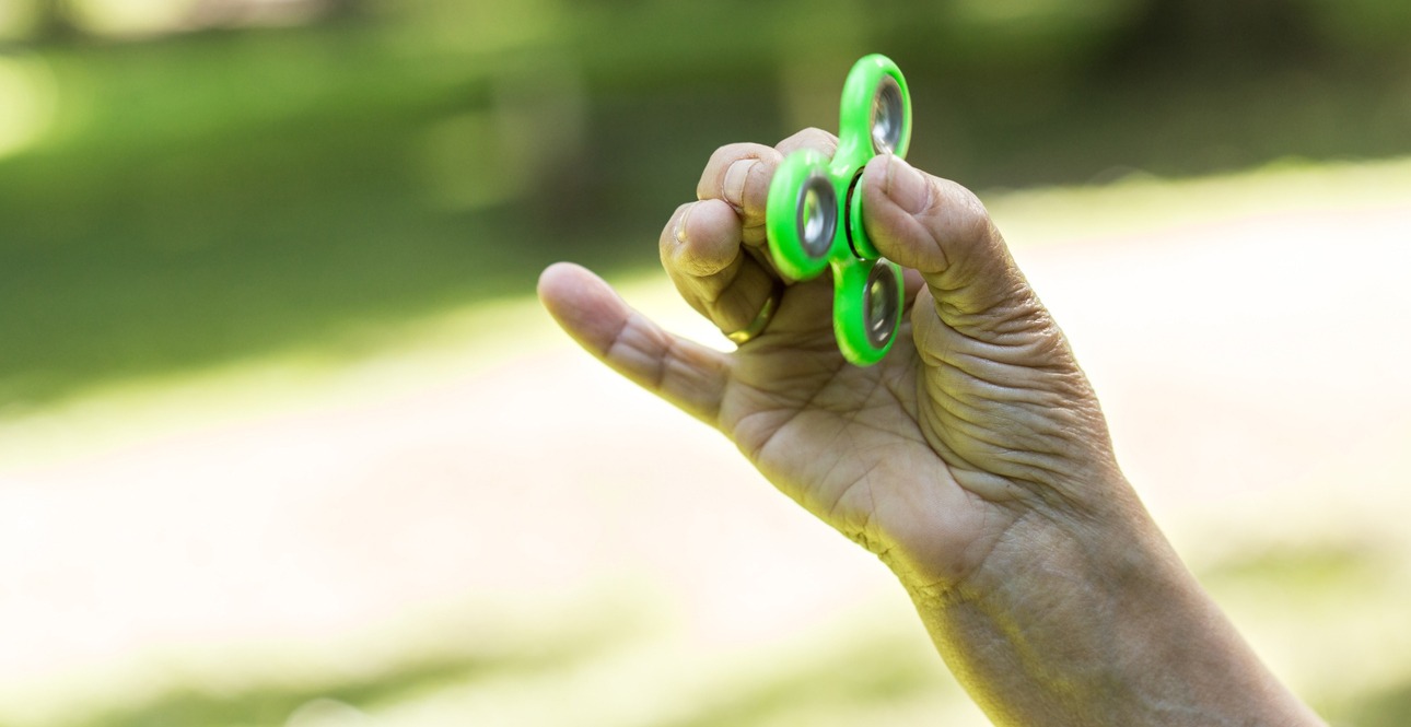 hand of a senior holding a fidget spinner