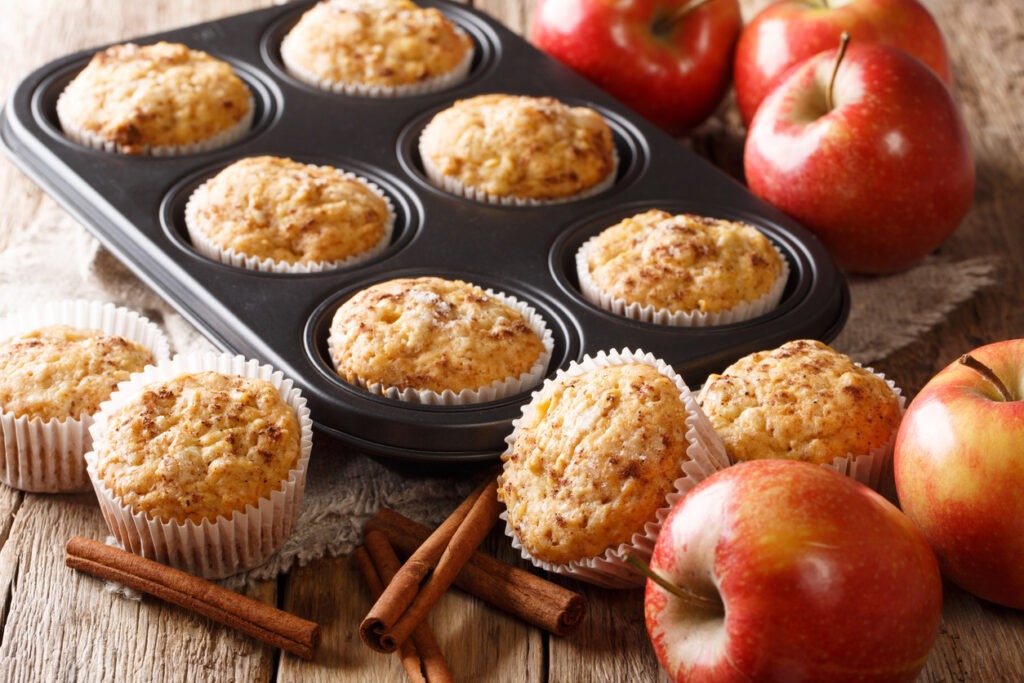 Sweet dessert apple muffins with a cinnamon close-up in a baking dish on the table. Horizontal
