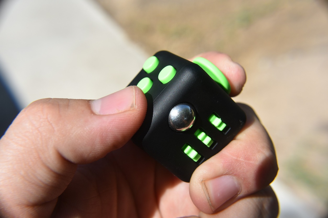 holding a fidget cube