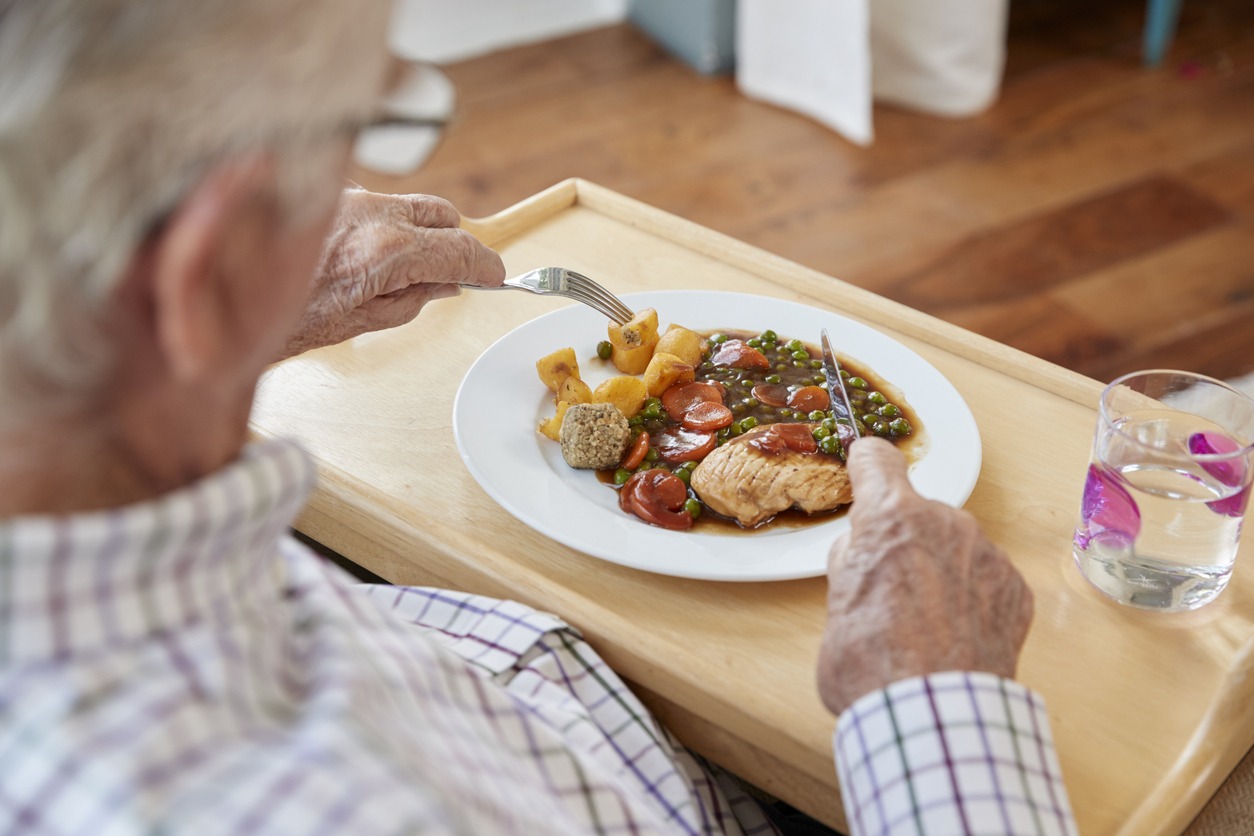 a senior man eating dinner