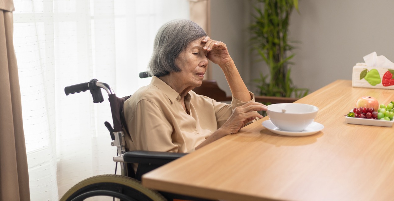 senior woman finding it hard to eat