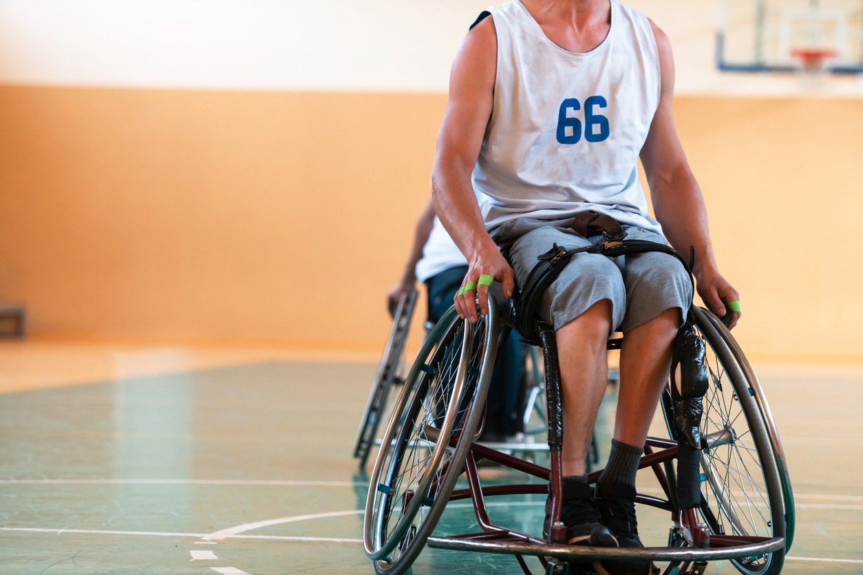 patient securing herself in a wheelchair with a lap belt