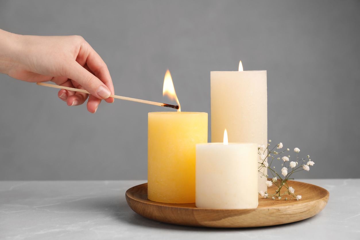 person lighting scented candles