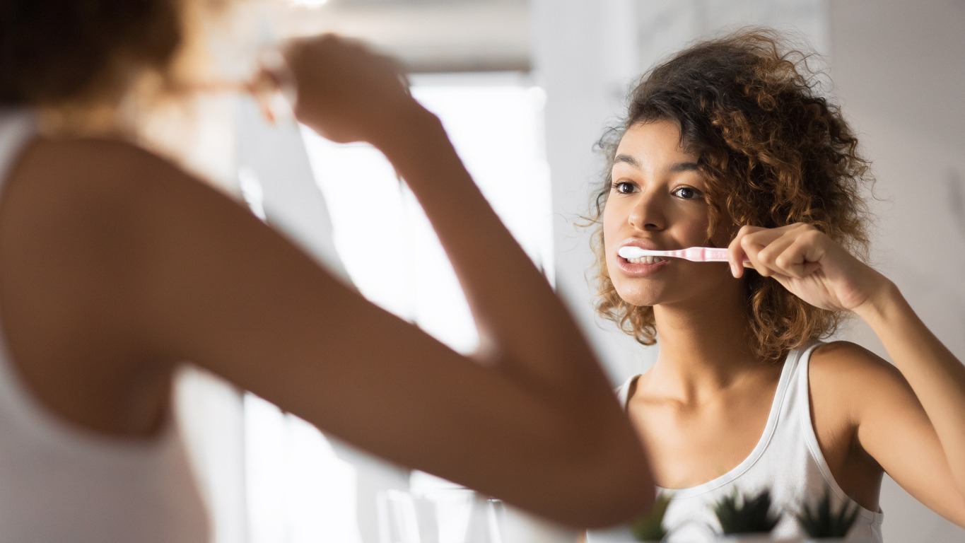 woman brushing her teeth