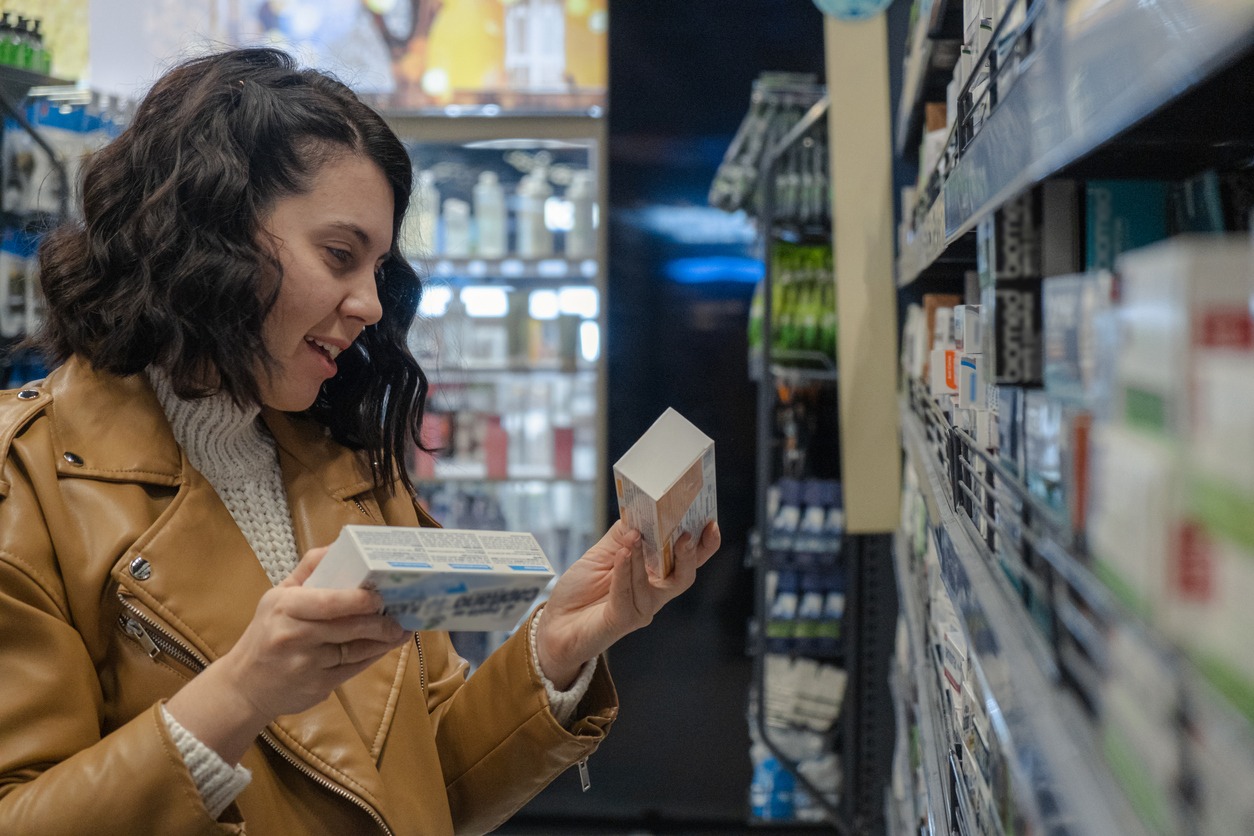 woman choosing toothpaste in the store