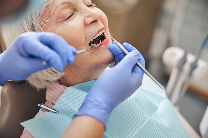 senior woman having her teeth checked in the dental clinic