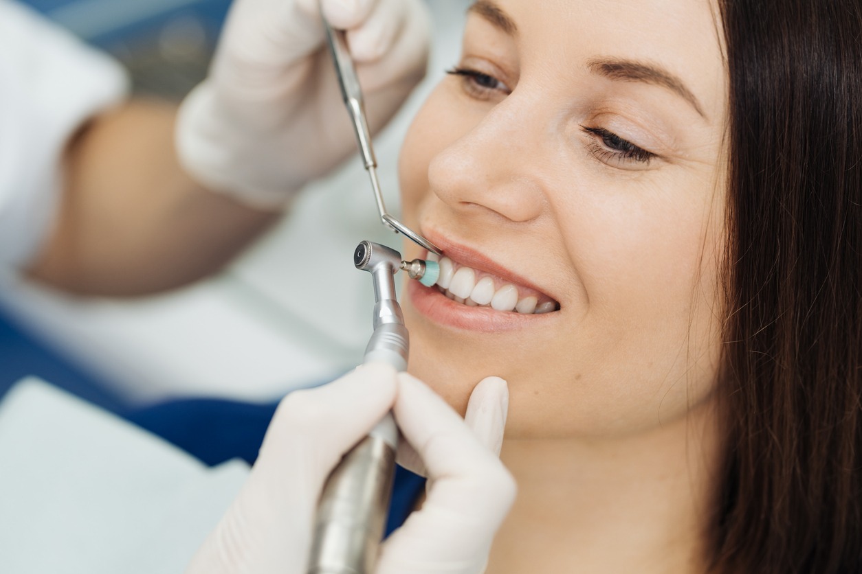 woman having her teeth cleaned in the dental clinic