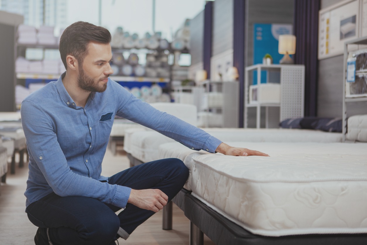 man checking a mattress