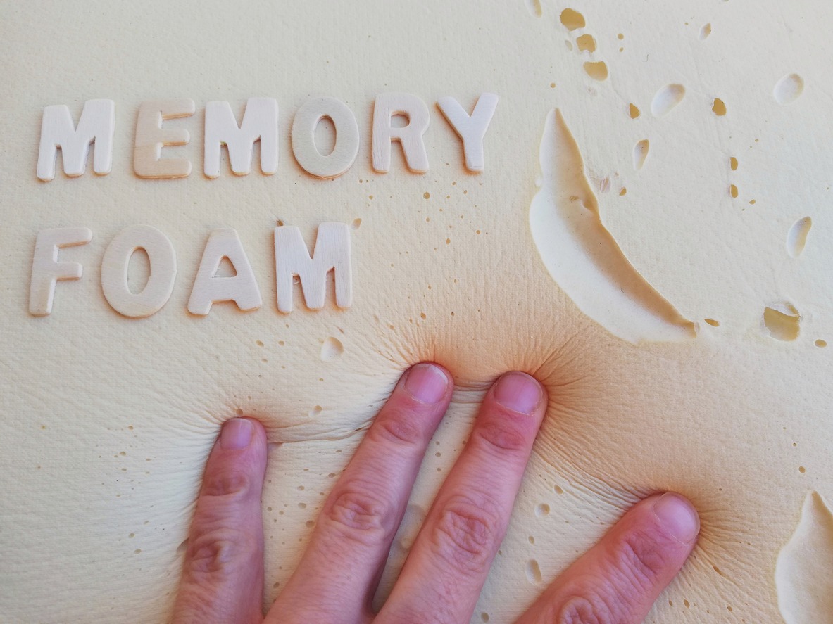 hand touching a memory foam