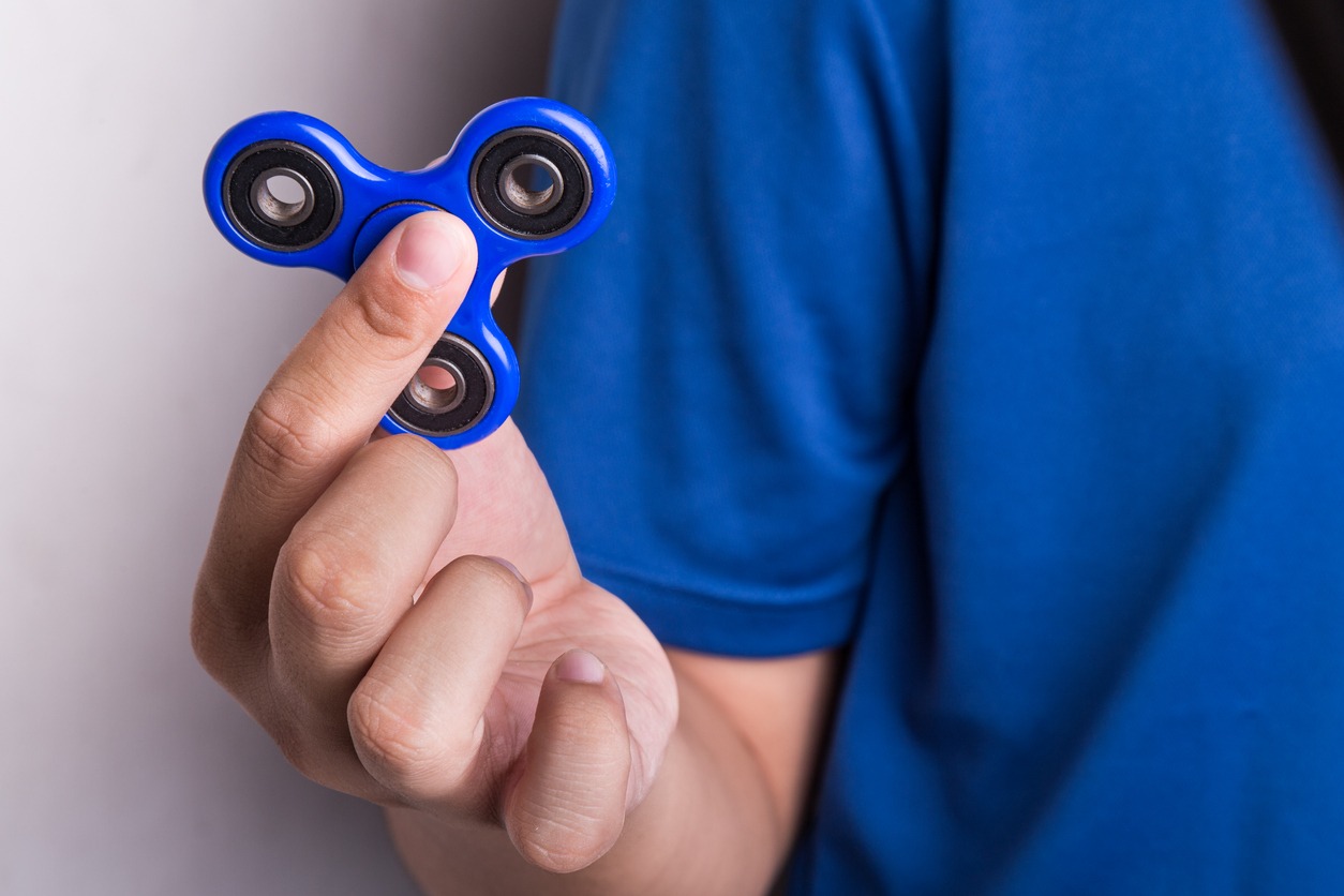 man holding a fidget spinner