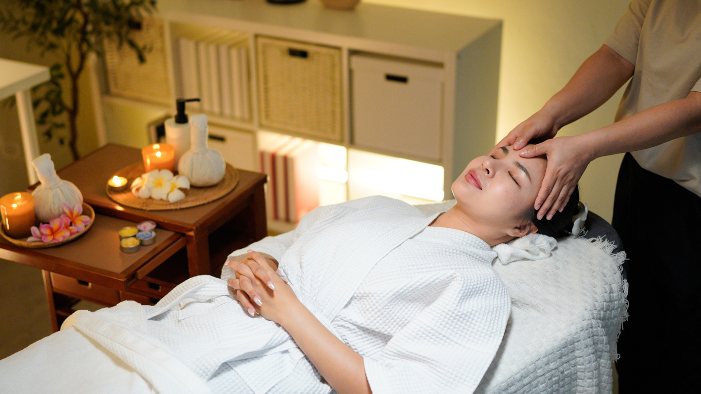 Young woman enjoys a calming facial treatment at a spa