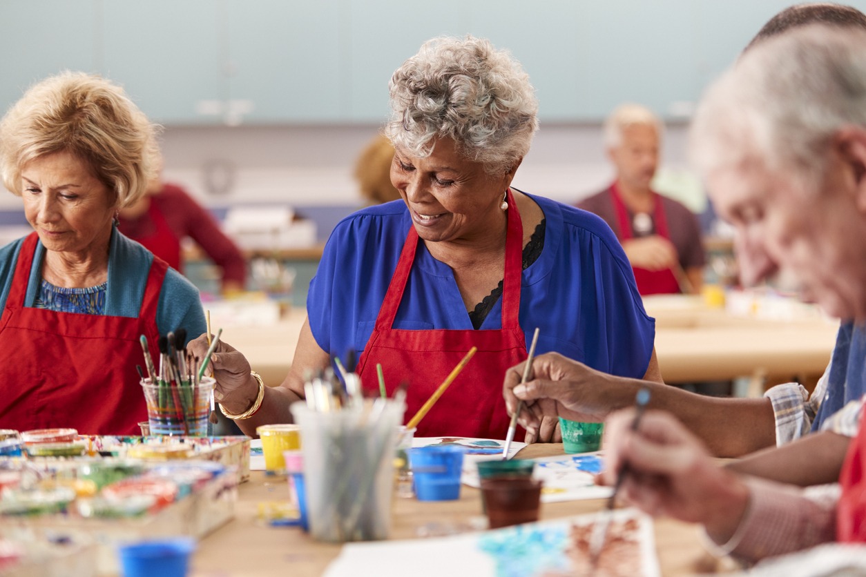 elderly women wearing red aprons