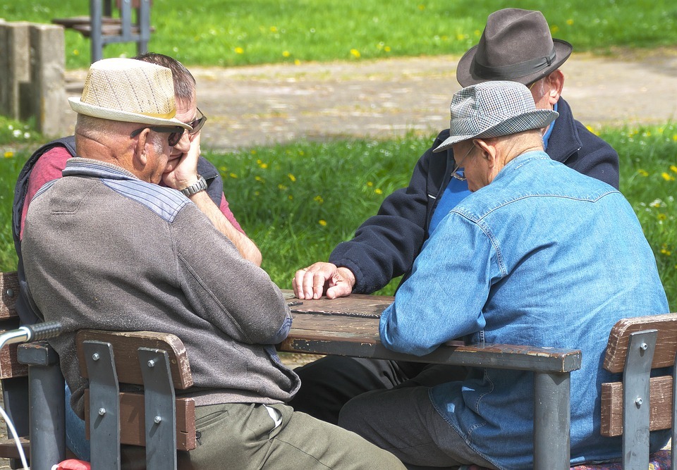 A group of seniors playing a tabletop game
