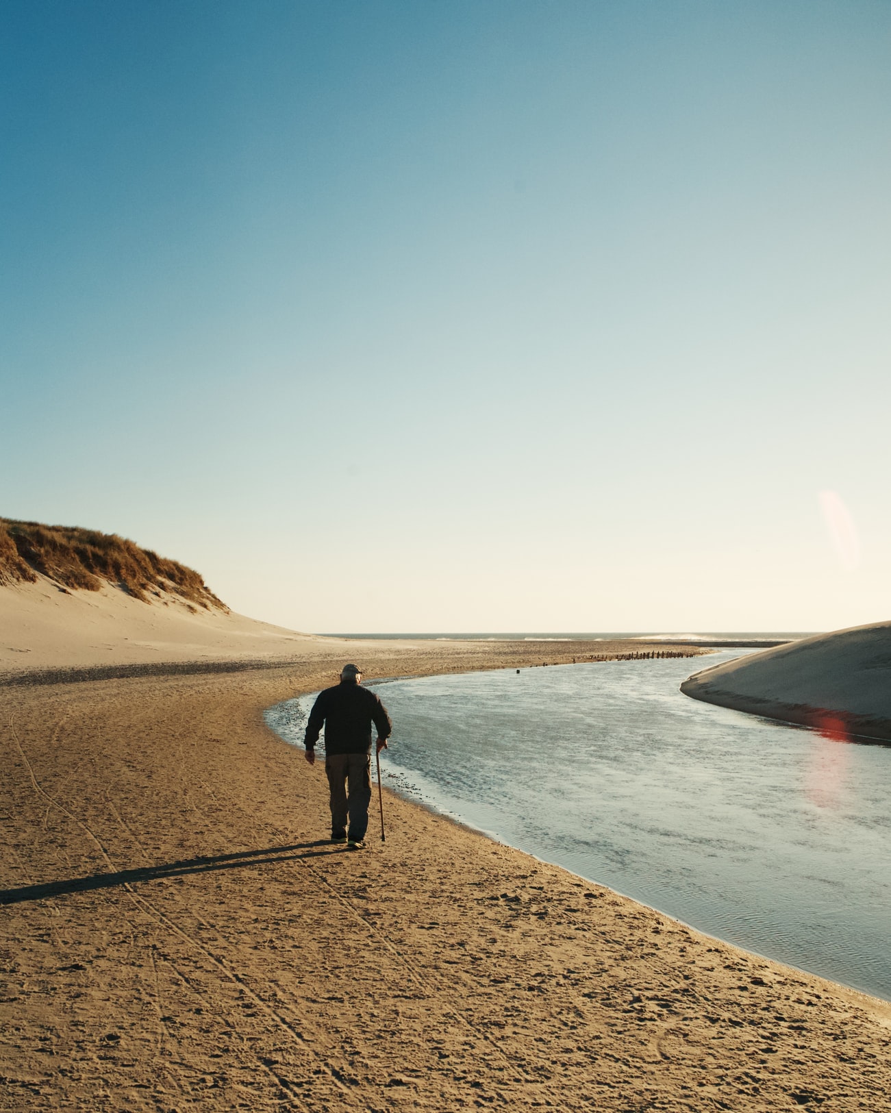 Old man walking on seashore
