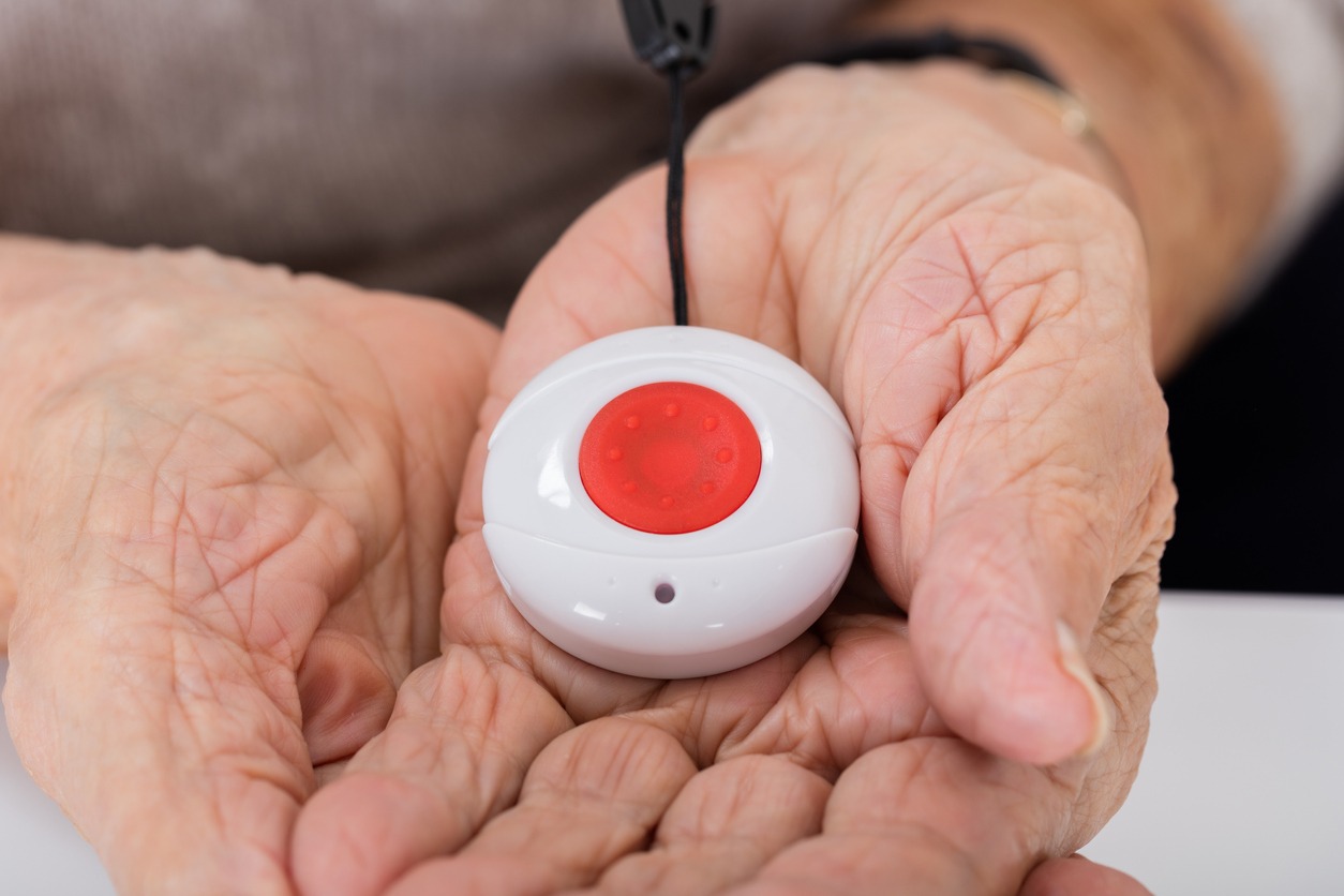 a panic button on a senior’s hands