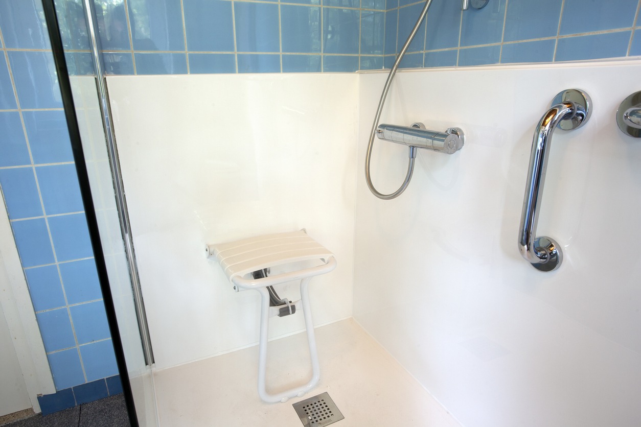 a shower seat inside the shower stall