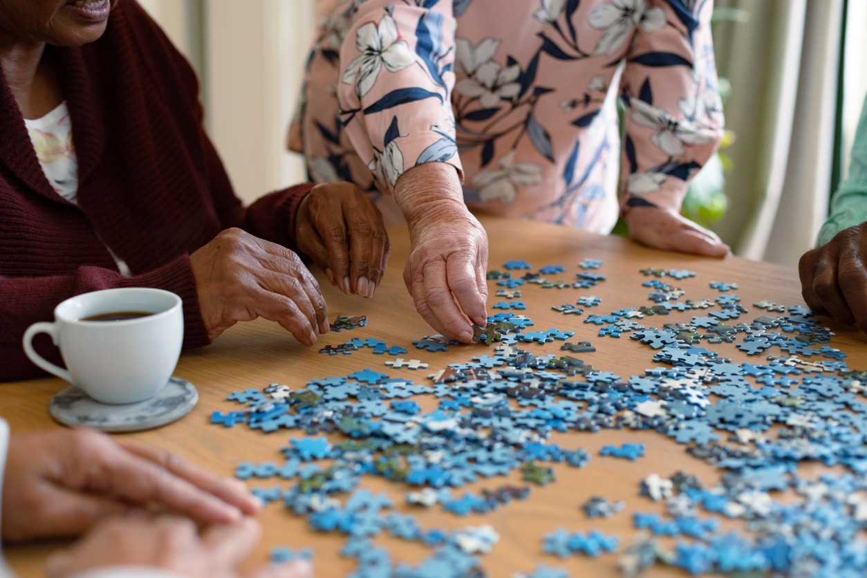 elderly people playing with puzzles