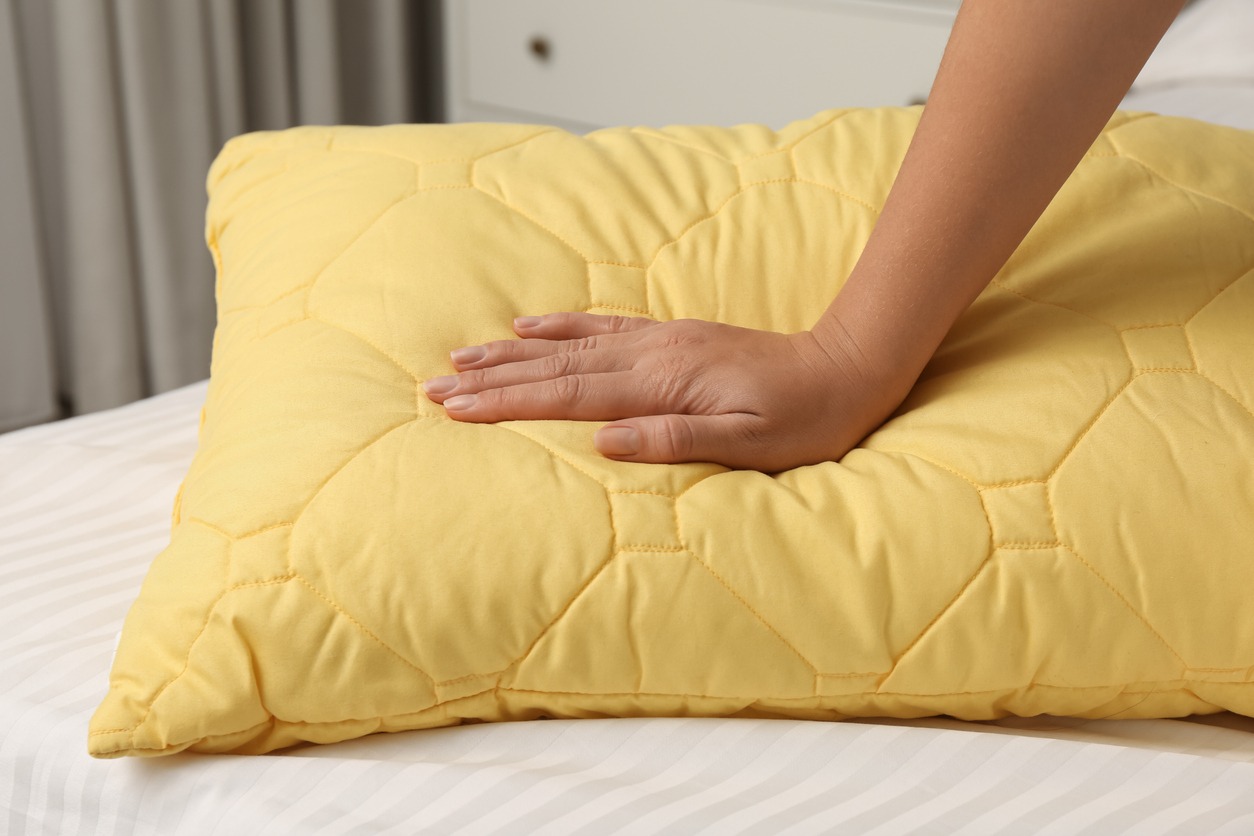 person touching a cushion
