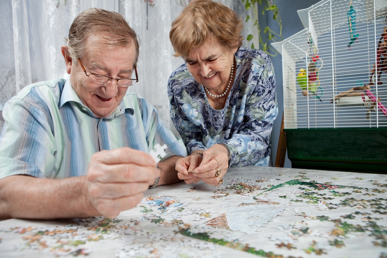 senior couple working on a jigsaw puzzle