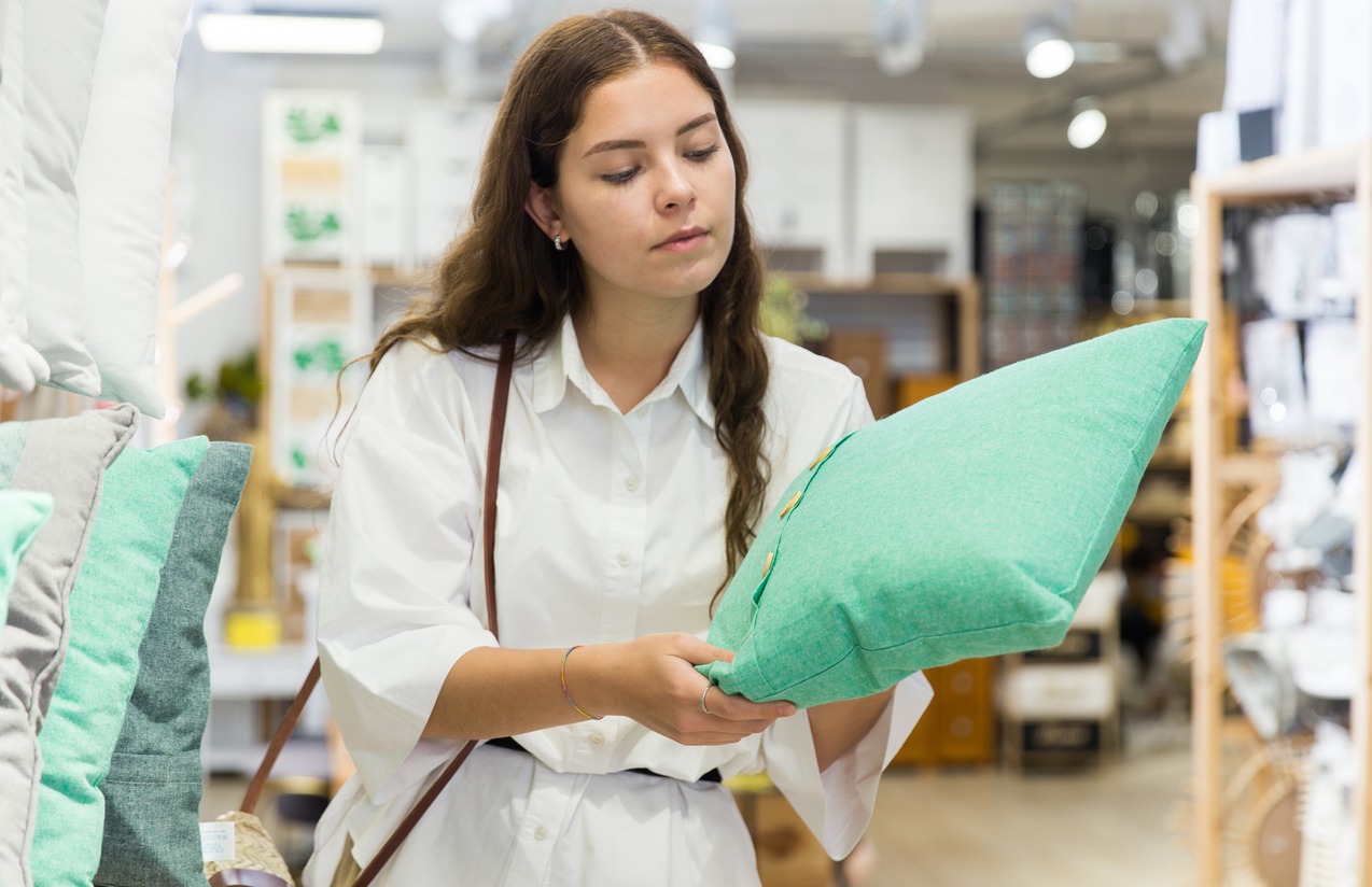 woman choosing a cushion in a store