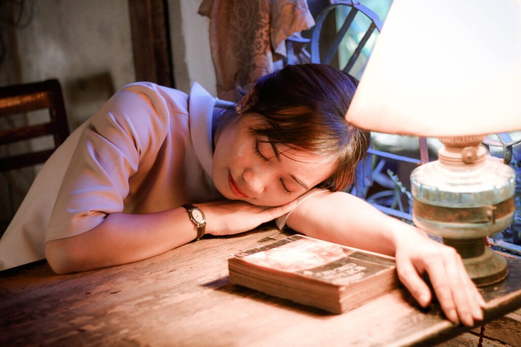 Woman sleeping on a study table
