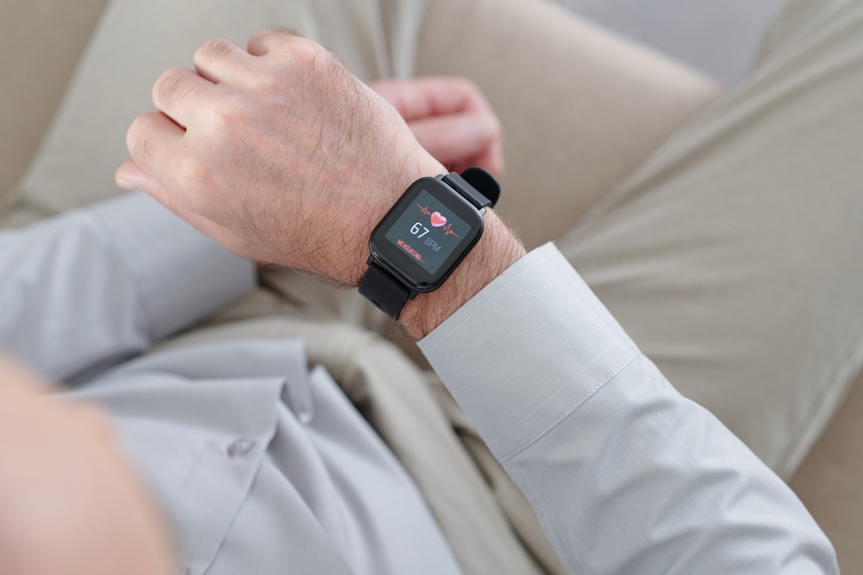 a senior man checking his heart rate using as smartwatch