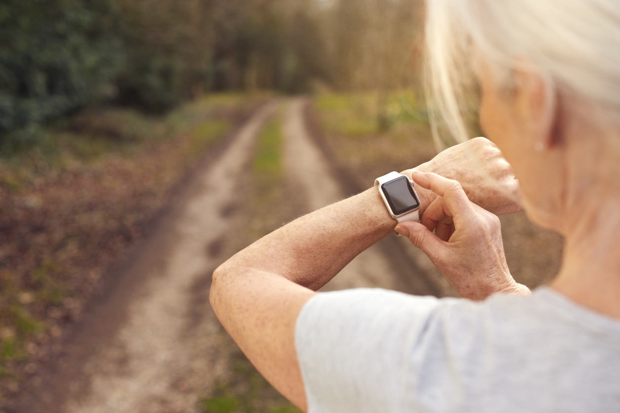 a senior woman using a smartwatch