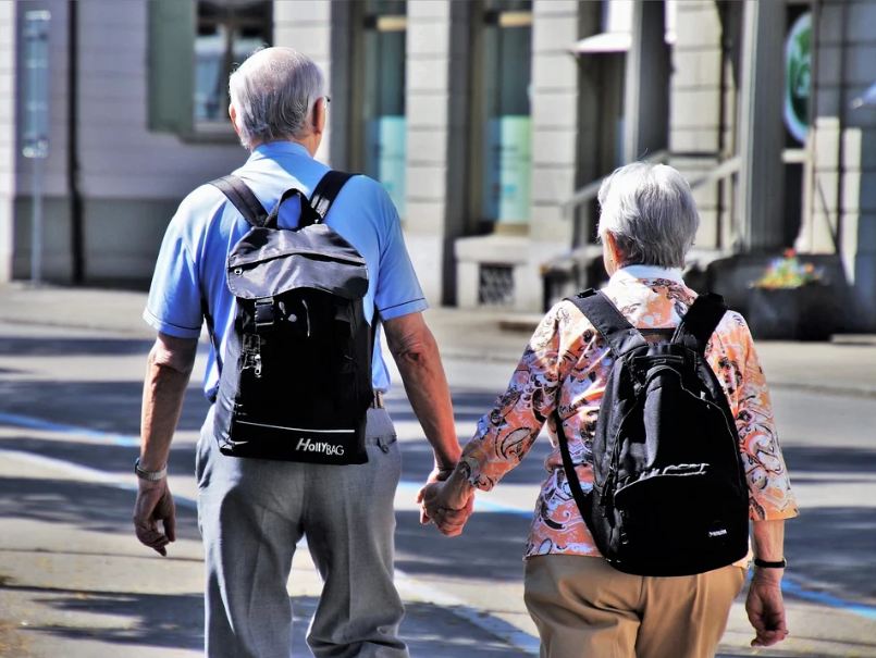 An elderly couple walking on the street
