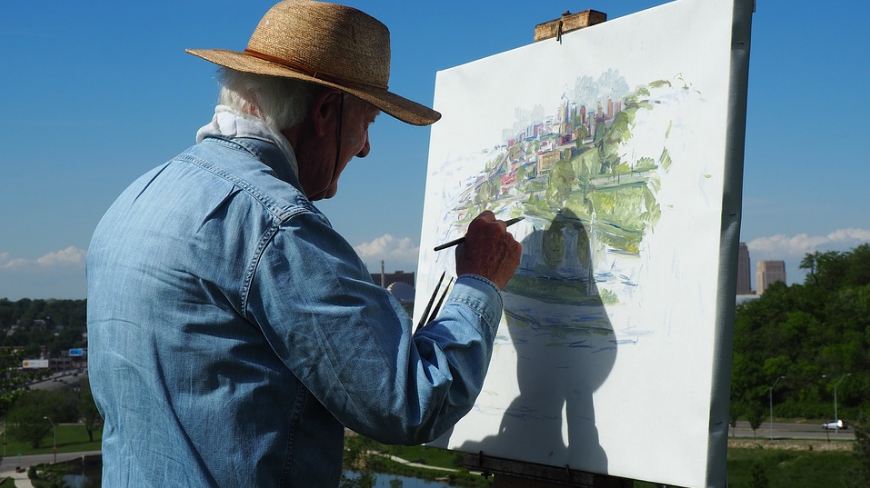 Image of an old man painting.