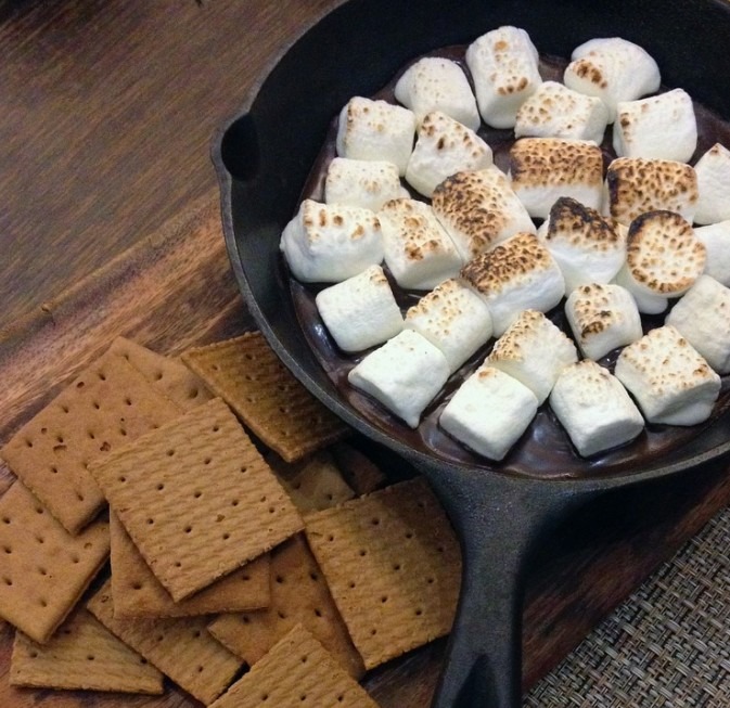 Marshmallows in a pot beside a stacking of crackers