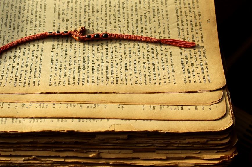Picture of a beaded bookmark placed in an old book.
