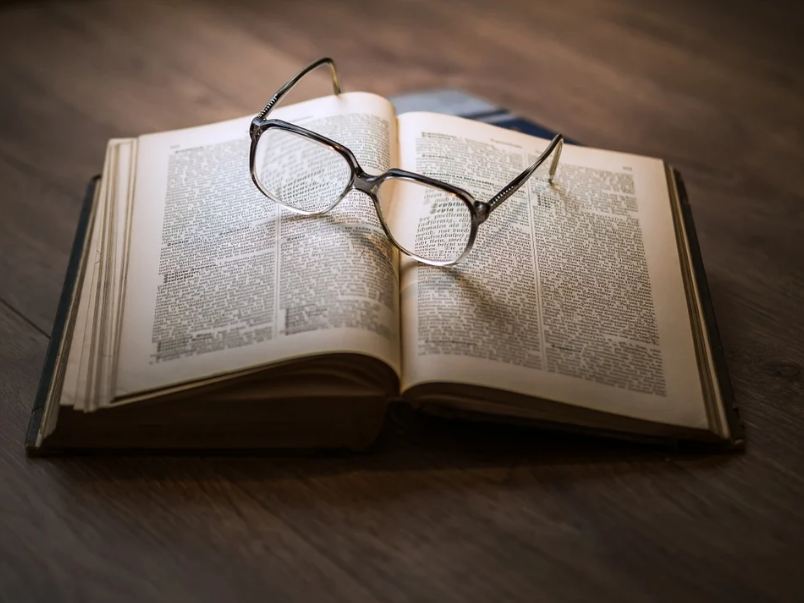 Picture of a book with glasses on it.