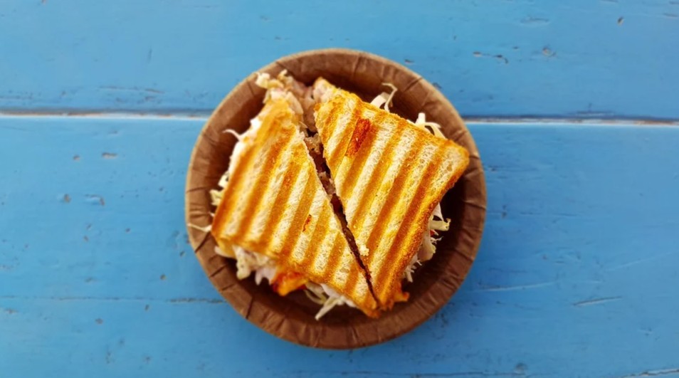 Sandwich cut in half on a wooden plate