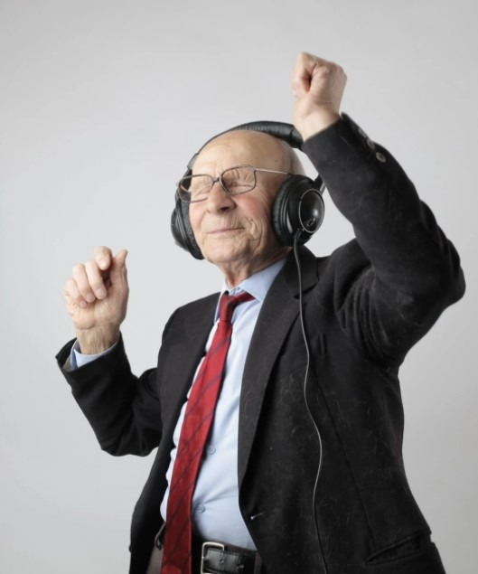 a senior citizen listening to music and dancing