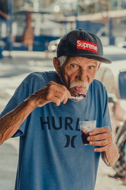 an old man eating icecream