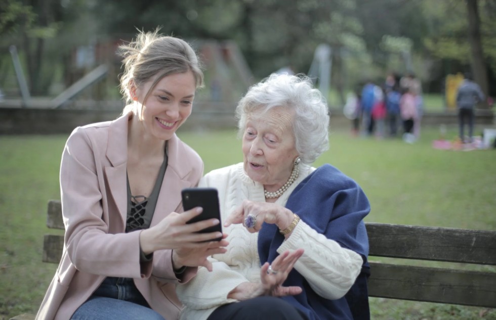 cheerful-senior-mother-and-adult-daughter-using-smartphone-together