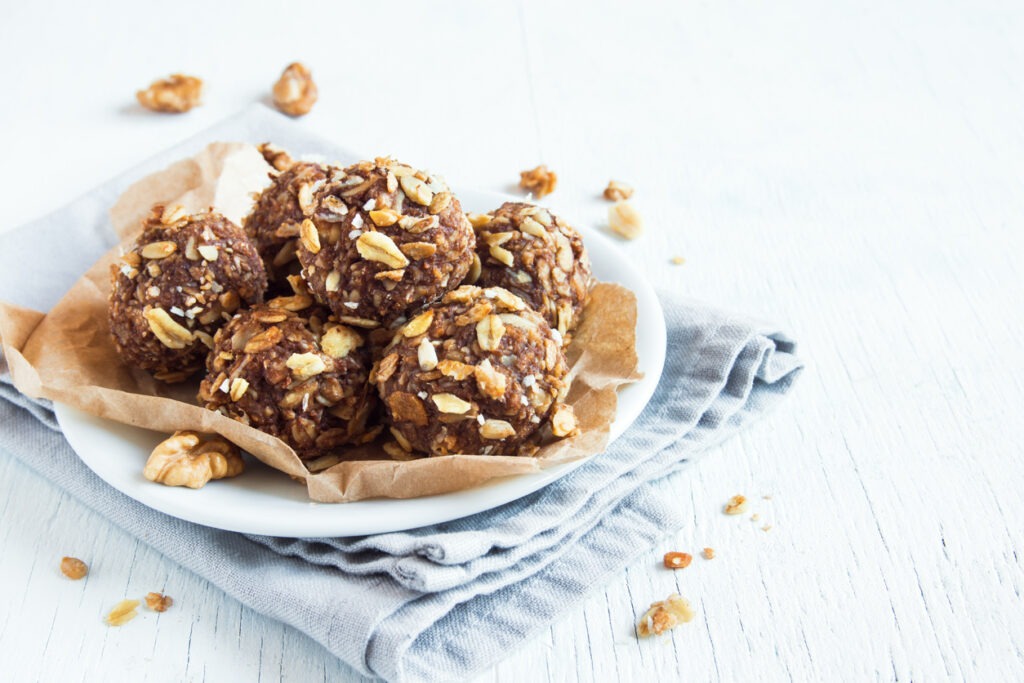 Healthy organic energy granola bites with nuts, cacao, banana, and honey - vegan vegetarian raw snack or meal