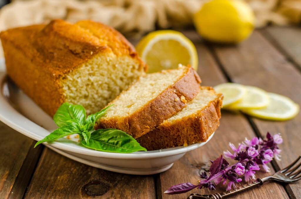 Lemon pound cake on rustic wooden background with lemon. Selective focus