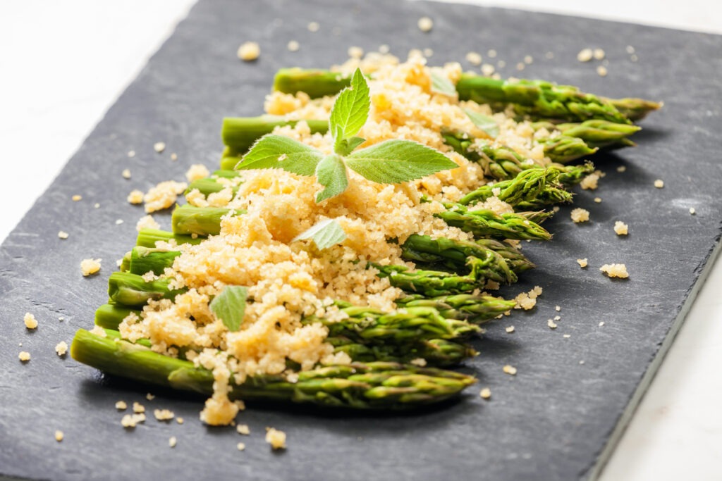 parmesan and breadcrumbs on green asparagus