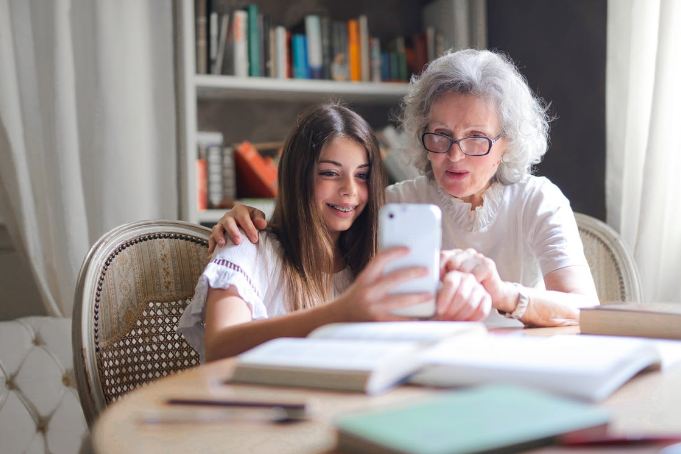 photo-of-woman-showing-her-cellphone-to-her-grandmother