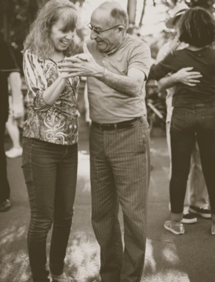 An elderly couple dancing