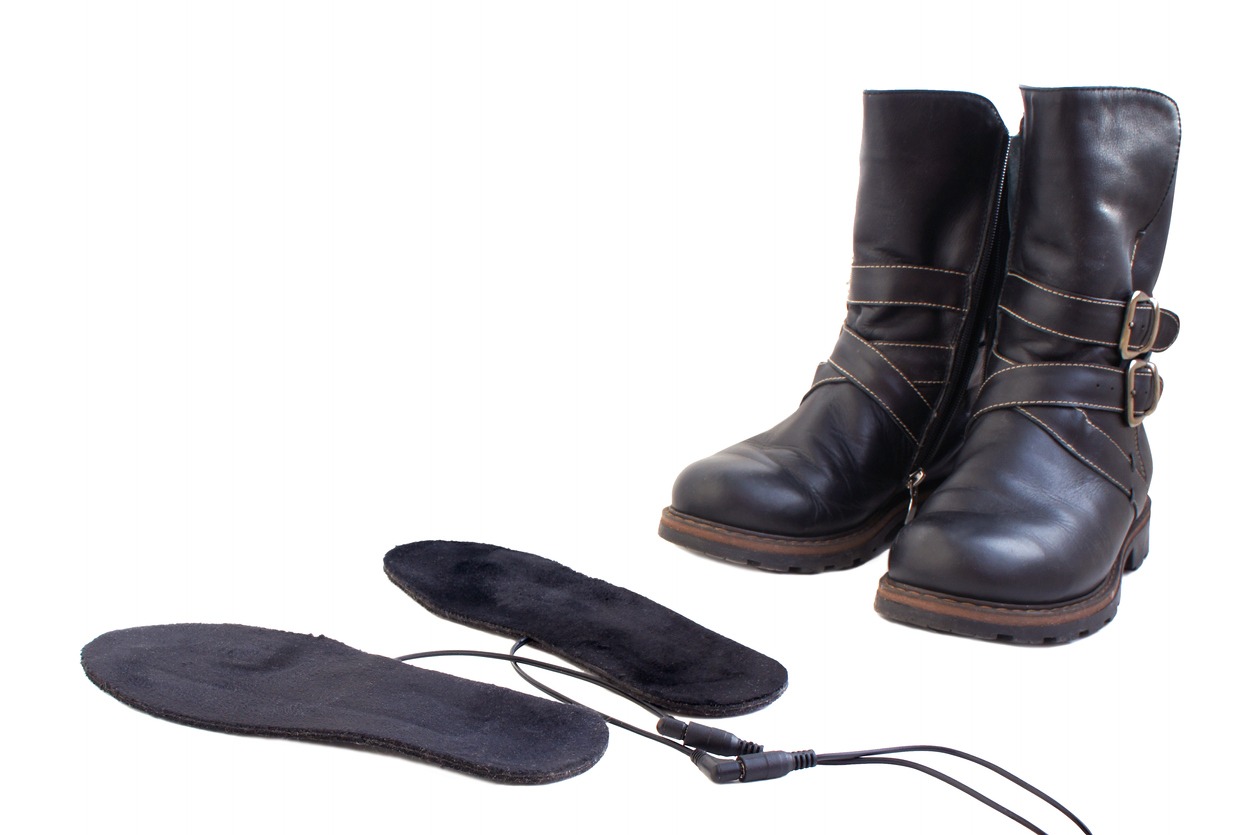 a pair of boots with remote-controlled heated insoles