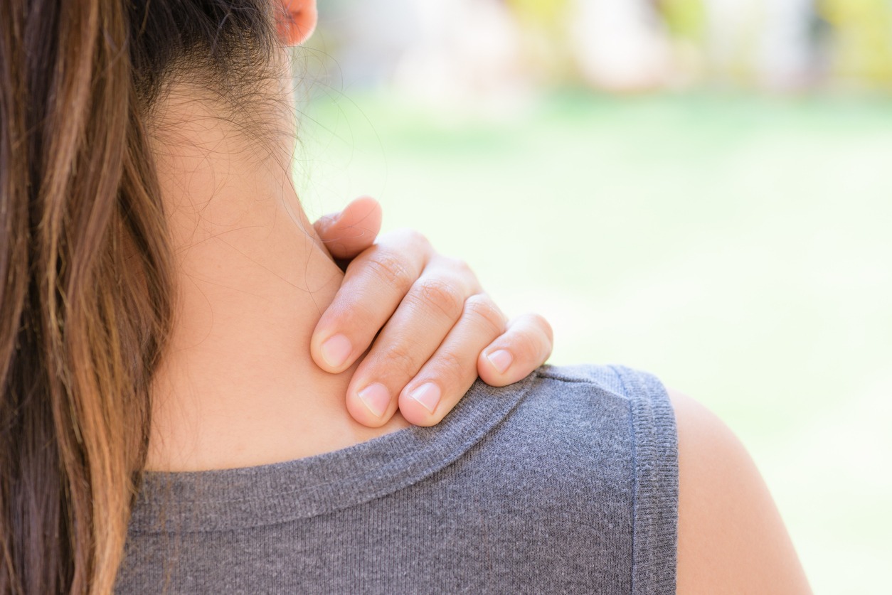 a woman experiencing neck and shoulder pain