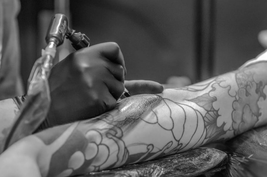 grayscale-photo-of-person-applying-tattoo