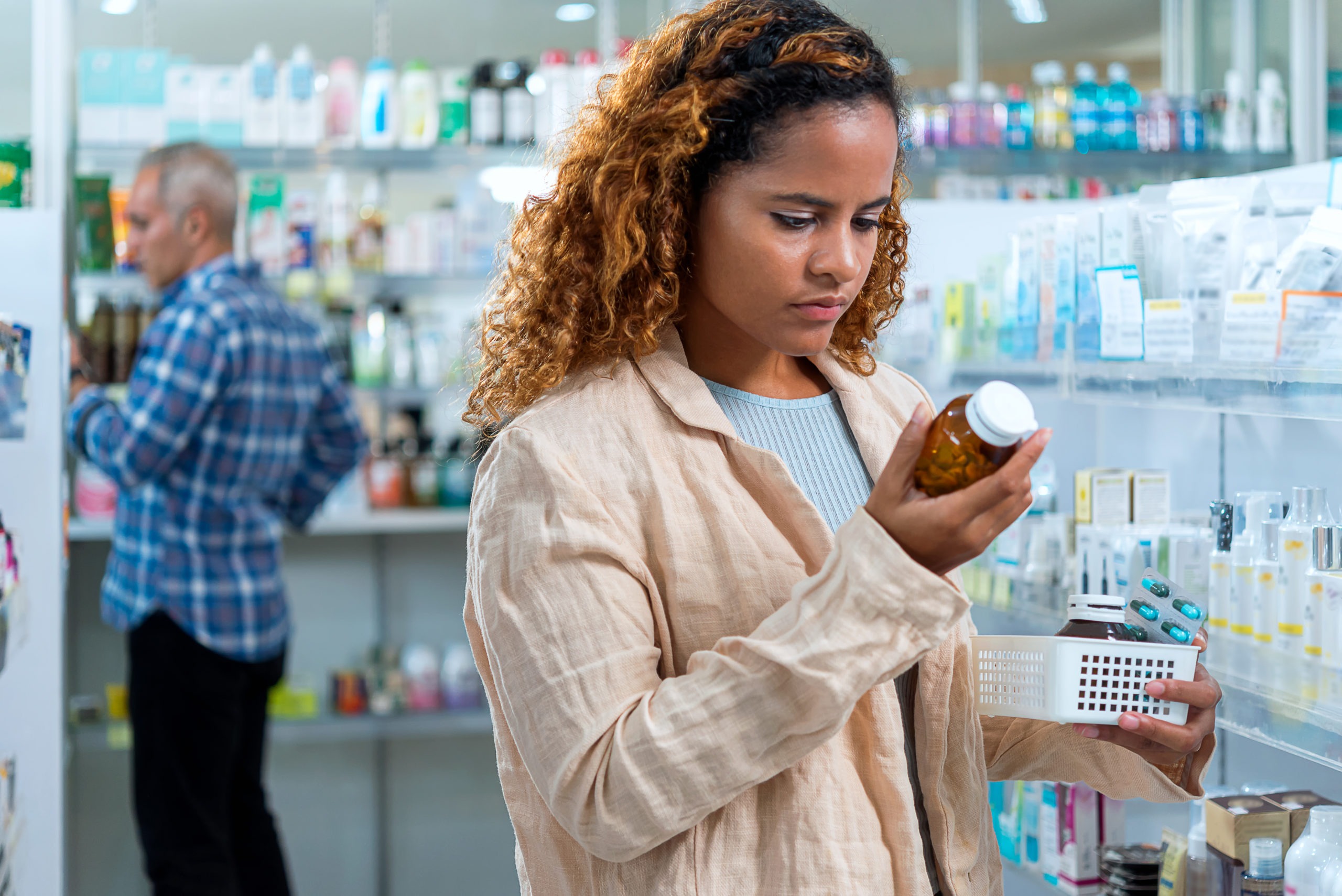 woman choosing medicines inside a pharmacy