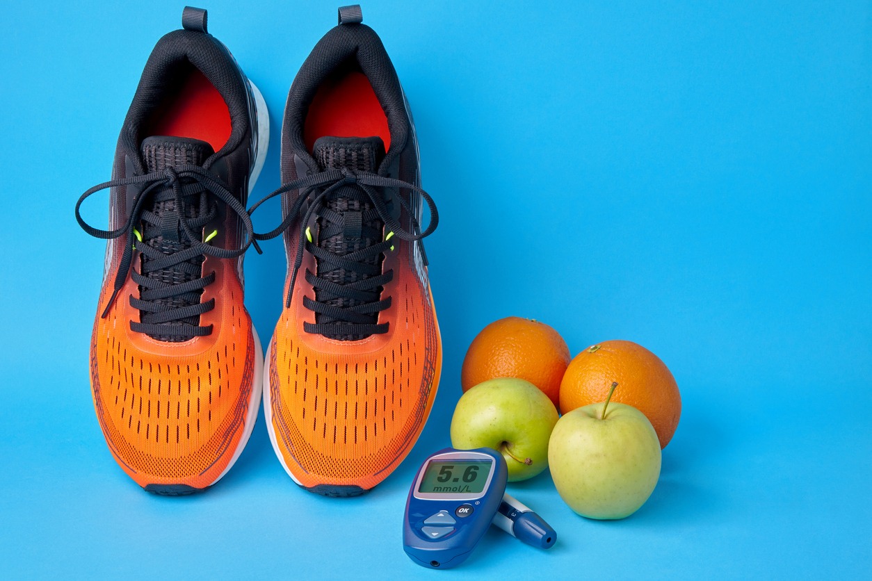 shoes with apples and a glucometer for measuring blood sugar level