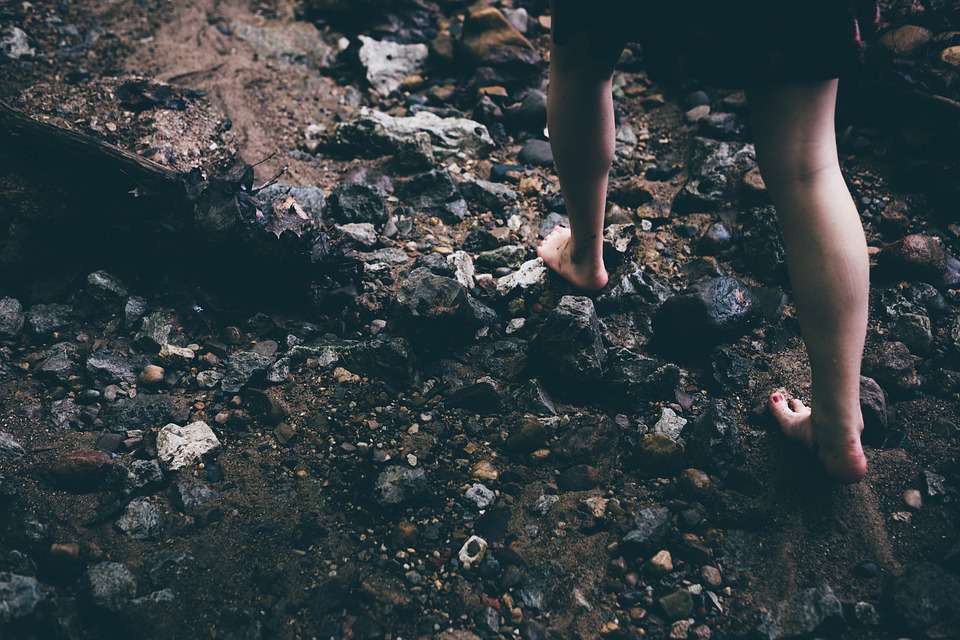 walking-barefoot-on-a-trail-full-of-rocks