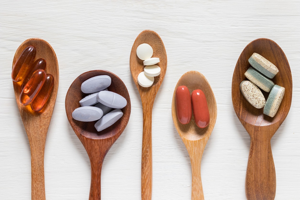 different supplements on wooden spoons