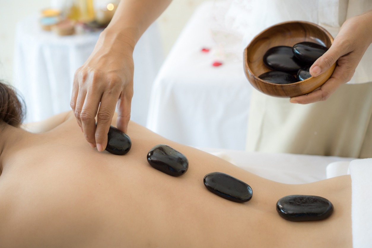 woman receiving a hot stone massage